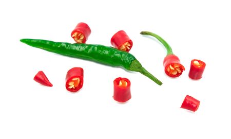 Slice pieces fresh red and green hot chilli spice vegetable herb. Tiny seed Isolated on white backgroundの写真素材