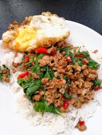 Thai street food is spicy basil minced pork on jasmine rice and fry egg.の写真素材