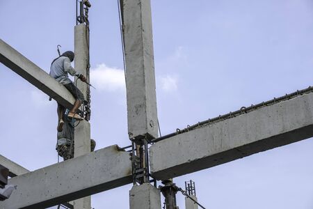 labor man working high pile no safety . Worker risk on top structure home building