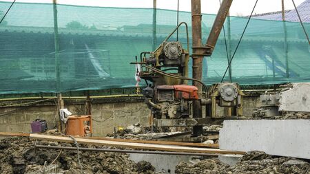 high tripod steel machine construction in site  piling equipment. Building house.  three legs metal...