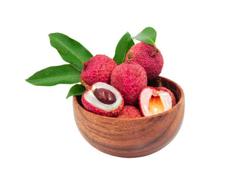 group of fresh red lychee sweet tropical fruit with green leaf in circle wooden bowl. Isolated on white background with clipping path.  organic fruits in Thailand summer season.の写真素材