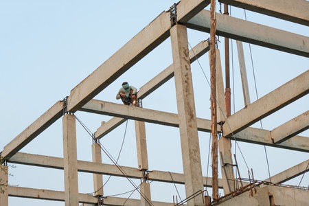 labor man working high pile no safety . Worker risk on top structure home building site.