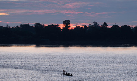 beautiful abstract twilight golden sun light sunset in sea behind island. silhouette fisherman boat....