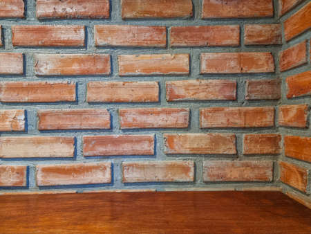 orange square shelf brick block on cement wall textured and background. strong interiors house building.の写真素材