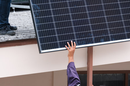 Electrician male working transport solar cell prepare for install aluminum rail . professional...