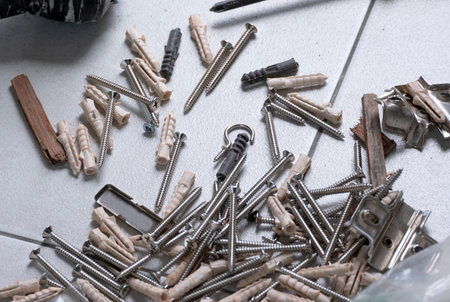 metal screw on floor . plastic screw anchor in toolkit. accessory equipmet for install and fixing concreteの写真素材