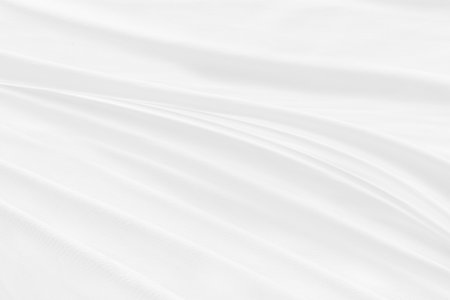 Clean soft white fabric woven abstract smooth curve shape decorative fashion textile backgroundの写真素材