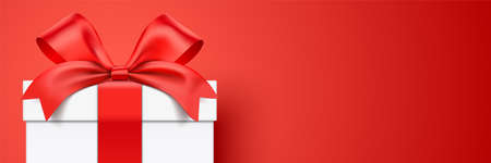 White gift box wrapped with ribbon standing on a red horizontal background with copy space. Realistic giftbox vector banner.のイラスト素材