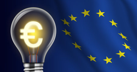 Light bulb with a shining Euro sign on a EU flag background. High electricity price creative concept...
