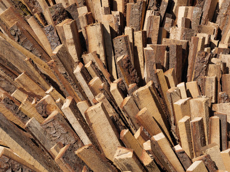 Neatly stacked firewood creates an organized, functional texture background.の写真素材