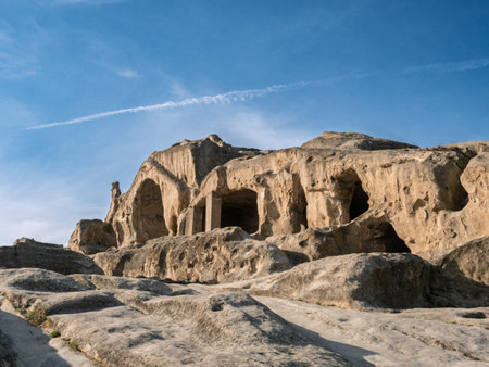 Georgian rock hewn settlement Uplistsikhe revealing ancient cave dwellings intricately carved within...