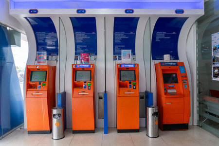 Row of ATMs in Malaysia, showcasing modern banking infrastructure, financial accessibility, and digital transaction services.の写真素材
