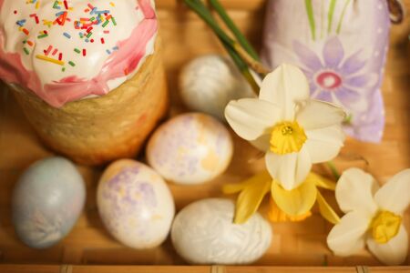 Easter cake and decoration eggs with daffodils flowers