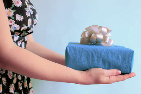 Gift box in woman's hands, give and receive a gift