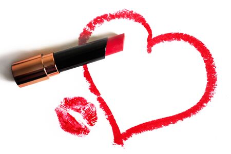 Painted heart by red lipstick and imprint of lips on a white backgroundの写真素材