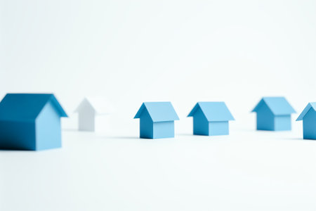 Blue houses on white background. Concept of real estate and property ladder.の素材