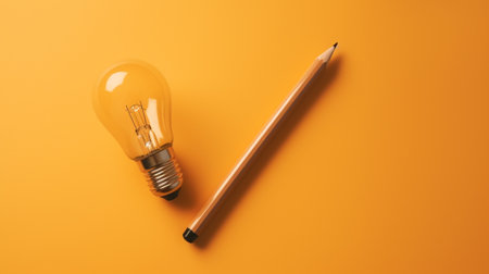 Pencil and light bulb on orange background, Creative idea concept.の素材