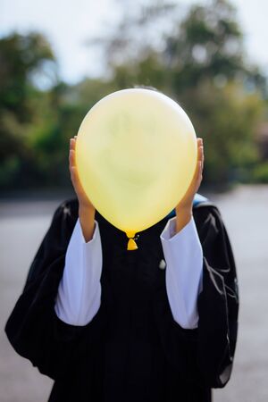 A person holding a yellow balloon on a happy date.