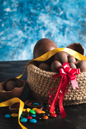 basket of chocolate Easter eggs, large and small with sprinklesの写真素材