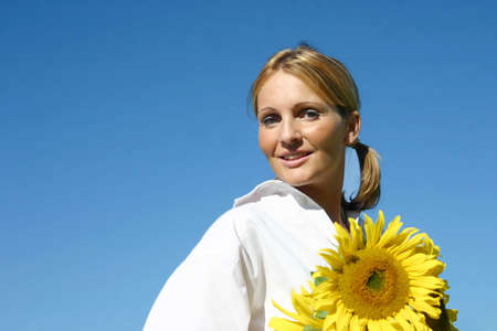 Beautiful Sunflower Woman and a blue sky.の写真素材