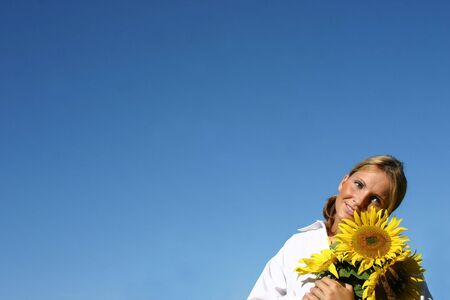 Beautiful Sunflower Woman and a blue sky.の写真素材