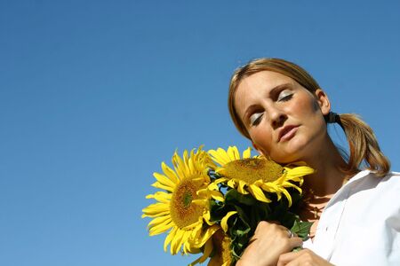 Beautiful Sunflower Woman and a blue sky.の写真素材