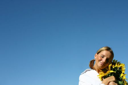 Beautiful Sunflower Woman and a blue sky.の写真素材