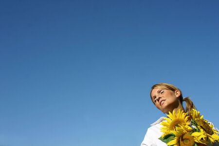 Beautiful Sunflower Woman and a blue sky.の写真素材