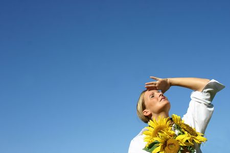Beautiful Sunflower Woman and a blue sky.の写真素材