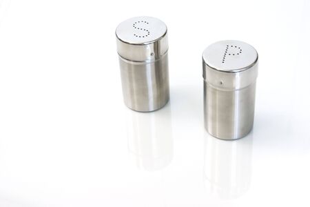 salt and pepper on white with reflectionの写真素材