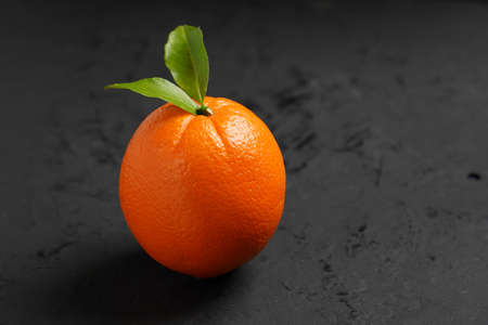 Fresh Orange fruit on black stone table background.Orange Fruitの写真素材
