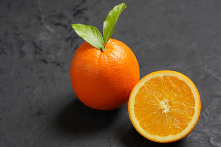 Fresh Orange fruit on black stone table background.Orange Fruitの写真素材