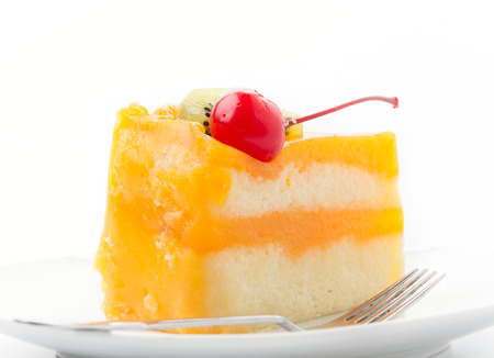 orange cake with kiwi and cherryの写真素材