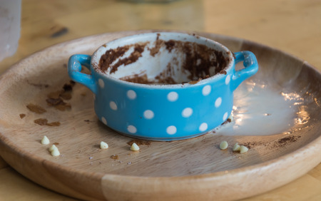 blow of chocolate cake on wood tableの写真素材