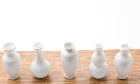 white vase on wood table