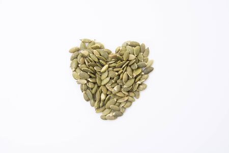 roasted pumpkin kernels isolated on white backgroundの写真素材