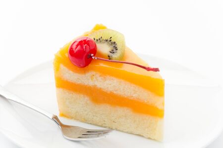 orange cake with kiwi and cherryの写真素材