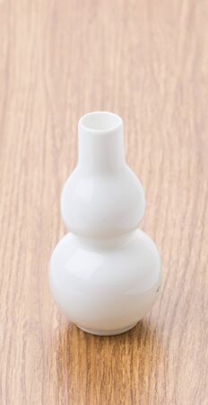 white vase on wood tableの写真素材