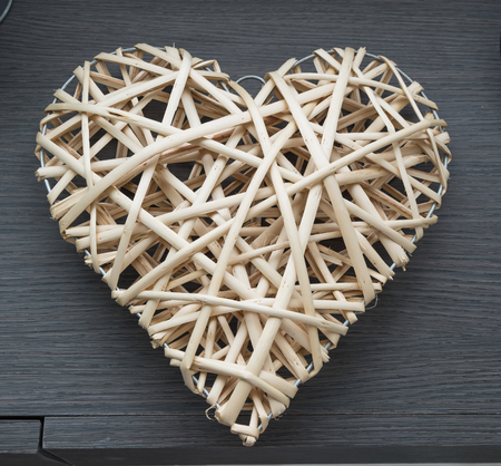 weaving heart on wood tableの写真素材