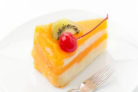 orange cake with kiwi and cherryの写真素材