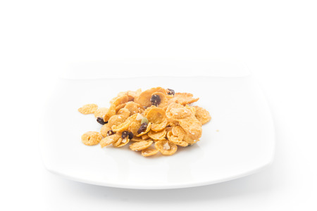 cornflakes and caramel isolated on white backgroundの写真素材