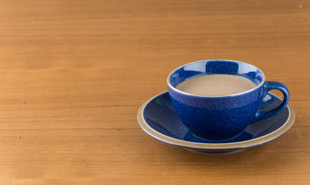 a cup of hot coffee on wood tableの写真素材