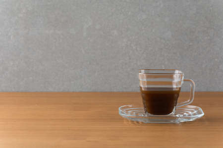 a cup of hot coffee on wood tableの写真素材