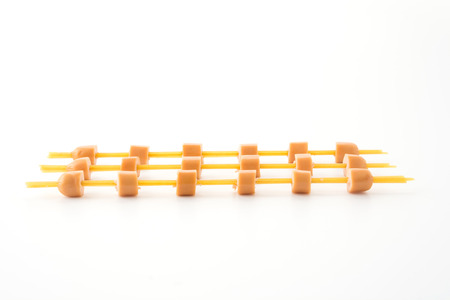 sausage with spagetti noodle on white backgroundの写真素材