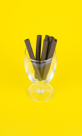 wafer sticks in glass on yellow backgroundの写真素材