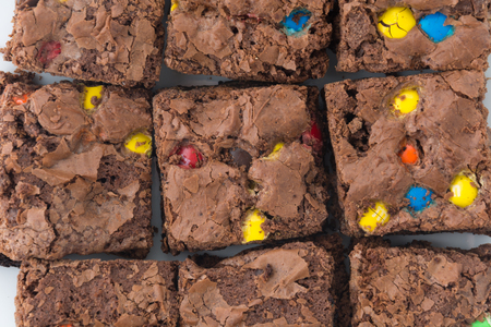 chocolate brownie with chocolate chips on white backgroundの写真素材