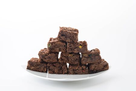 chocolate brownie with chocolate chips on white backgroundの写真素材