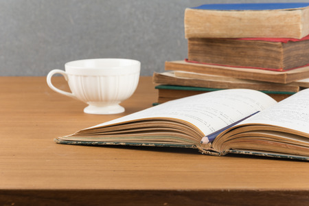 old book with pencil and coffeeの写真素材
