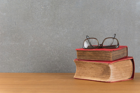 stack of old books with glassesの写真素材