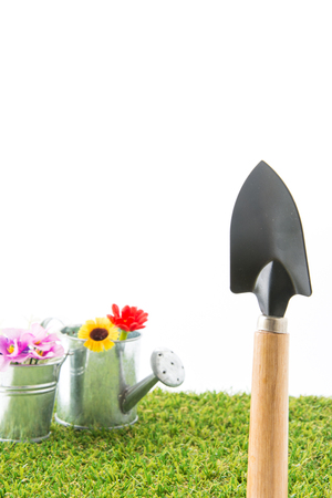 green grass turf on white with spade ,fail and watering canの写真素材